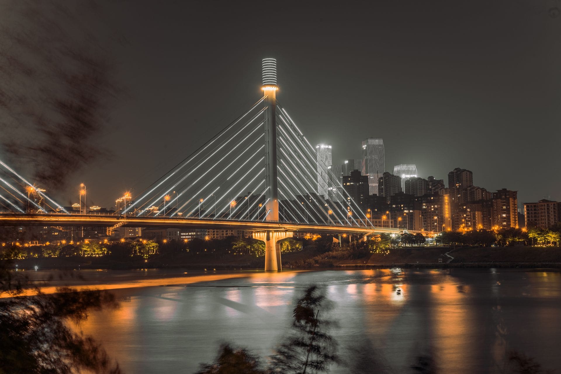 Captivating night view of a modern cable-stayed bridge in Nanning, Guangxi with city skyline.