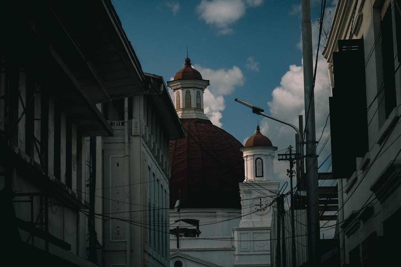 Capture of the iconic Blenduk Church's dome amidst the urban setting of Semarang, Indonesia.