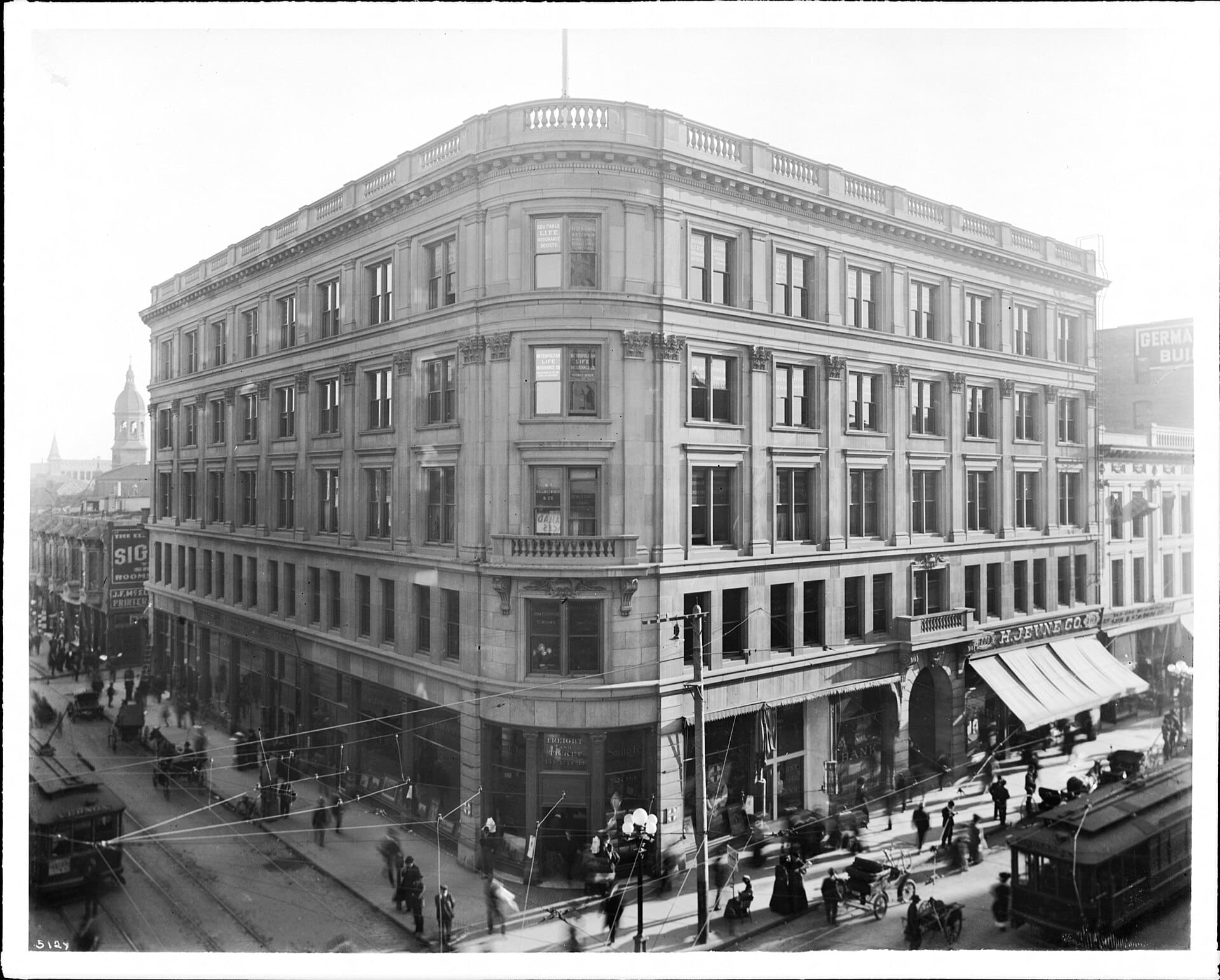 Exterior view of the Wilcox Building on the southeast corner of Spring Street and 2nd Street, ca.1905 Photograph of the exterior facades of the Wilcox Building, located in Downtown Los Angeles, on the southeast corner of 2nd Street (left, eastbound) and Spring Street (right, southbound) ca.1905. The building stands five-stories tall (plus basement). The roof has a concrete balustrade and a flagpole. There are two narrow balconies visible, one on the corner (center), and one on the right side of the building above the large arched Spring Street entrance. The streets are bustling with pedestrian and vehicular traffic. Horse drawn carriages and streetcars can be seen on the streets. The bell tower of Saint Vibiana's Cathedral can be seen at left. Legible signs include: "the El[...], Sig[...], rooms", "J.F. McEl[...], printer[s]", "First National Bank", "California railway", "Santa Fe", "Freight and Ticket Office", "200", "Vernon", "Equitable Life Assurance Society", "Fred A. Hines, A.P. Chipron, general agent, Douglas E. Poole, cashier", "Metropolitan Life Insurance Co., incorporated by the state of New York, district office", "W.I. Hollingsworth &amp; Co.", "real estate loans", "John T. Griffith Company", "real estate insurance, rentals, loans", "Dr. Cowles, chief medical examiner", "Germa[n] Bu[ilding]", "Union [...]efining", "Douglas, Lacey &amp; Co.", "law offices of R. Wilson", "Doctor Solomon, eyes, ears, nose, and throat", "808, H. Jevne Co." The Wilcox Building was designed by the San Francisco firm of Pissis &amp; Moore, with a Classical Revival facade of grey sandstone. Completed in 1896. The Bryson Block and Hollenbeck Hotel were "more flamboyant neighbors." After extensive damage during the Sylmar Earthquake in 1971, its upper four stories were demolished, leaving only the basement and the unrecognizable stripped facade of the ground floor. Call number: CHS-5129 Legacy record ID: chs-m1101; USC-1-1-1-1137 Filename: CHS-5129 Coverage date: circa 1905 Part of collection: California Historical Society Collection, 1860-1960 Type: images Geographic subject (city or populated place): Los Angeles Repository name: USC Libraries Special Collections Accession number: 5129 Microfiche number: 1-9-52 Archival file: chs_Volume25/CHS-5129.tiff Part of subcollection: Title Insurance and Trust, and C.C. Pierce Photography Collection, 1860-1960 Repository address: Doheny Memorial Library, Los Angeles, CA 90089-0189 Geographic subject (country): USA Format (aacr2): 3 photographs : glass photonegative, photonegative, photoprint, b&amp;w ; 21 x 26 cm. Rights: Digitally reproduced by the USC Digital Library; From the California Historical Society Collection at the University of Southern California Subject (adlf): buildings Project: USC Repository email: specol@usc.edu Contributing entity: California Historical Society Date created: circa 1905 Publisher (of the digital version): University of Southern California. Libraries Format (aat): negatives (photographic); photographs Geographic subject (state): California Subject (file heading): Los Angeles -- Architecture -- Commercial -- General #2; Los Angeles -- Architecture -- Commercial -- General -- Wilcox Building Format: glass plate negatives Access conditions: Send requests to address or e-mail given. Phone (213) 821-2366; fax (213) 740-2343. Geographic subject (county): Los Angeles Geographic subject (roadway): Spring Street &amp; 2nd Street Subject (lcsh): Buildings Subject: Wilcox Building, built 1896