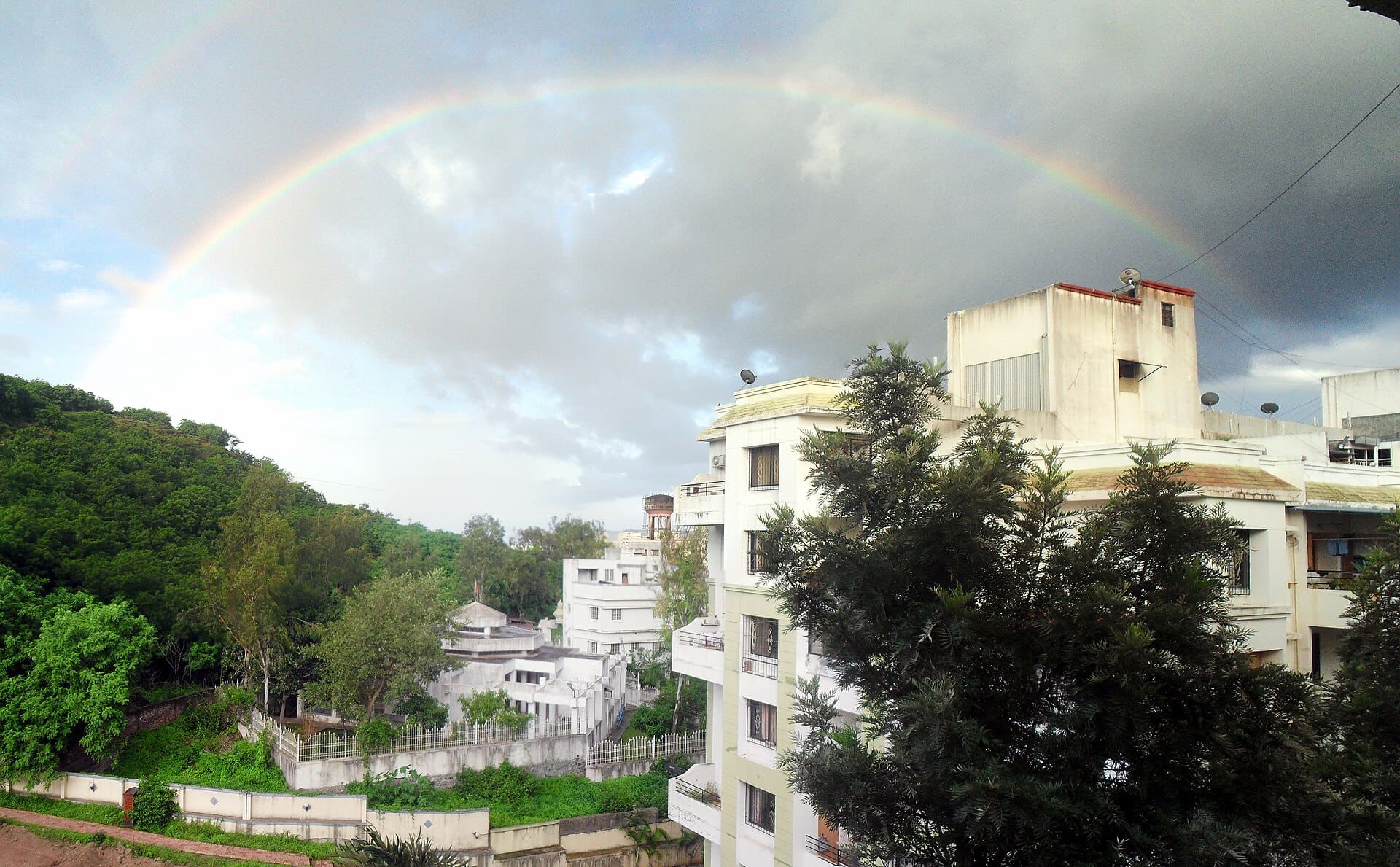 A rainbow over the skies of Pune, India. A secondary ring is visible in the top-left corner.
