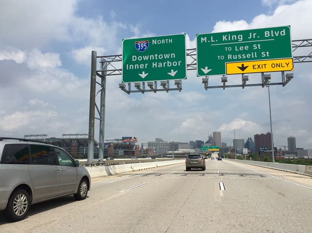 View north along Interstate 395 (Cal Ripken Way) approaching the exit for Martin Luther King, Junior Boulevard (TO Lee Street, TO Russell Street) in Baltimore City, Maryland