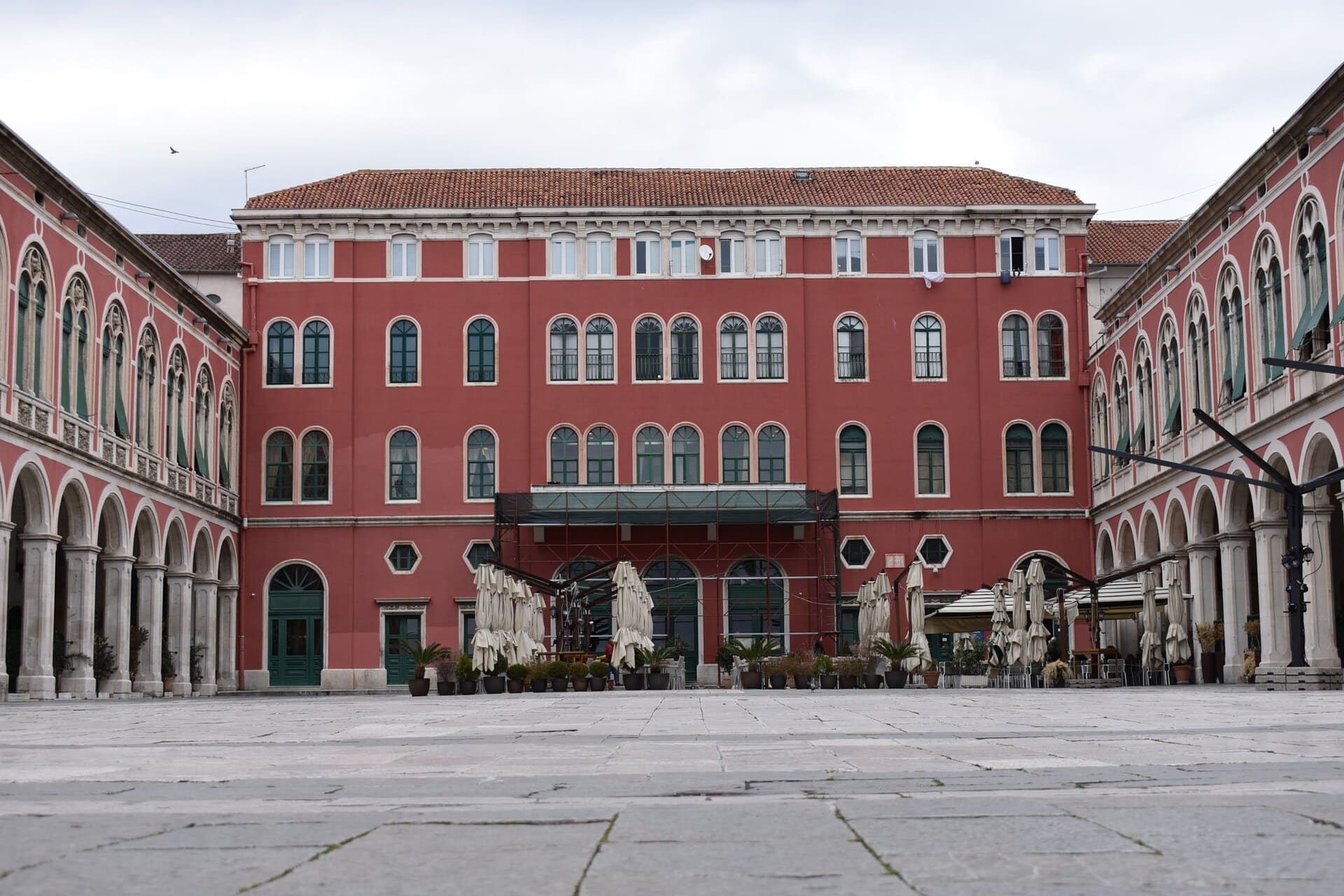 500px provided description: Looking into a plaza in Split, Croatia. [#sky ,#city ,#architecture ,#cityscape ,#building ,#brick ,#town ,#skyline ,#architectural ,#historical ,#plaza ,#historic ,#Europe ,#Croatia ,#Split ,#Mediterranean ,#Balkans ,#Split Croatia]