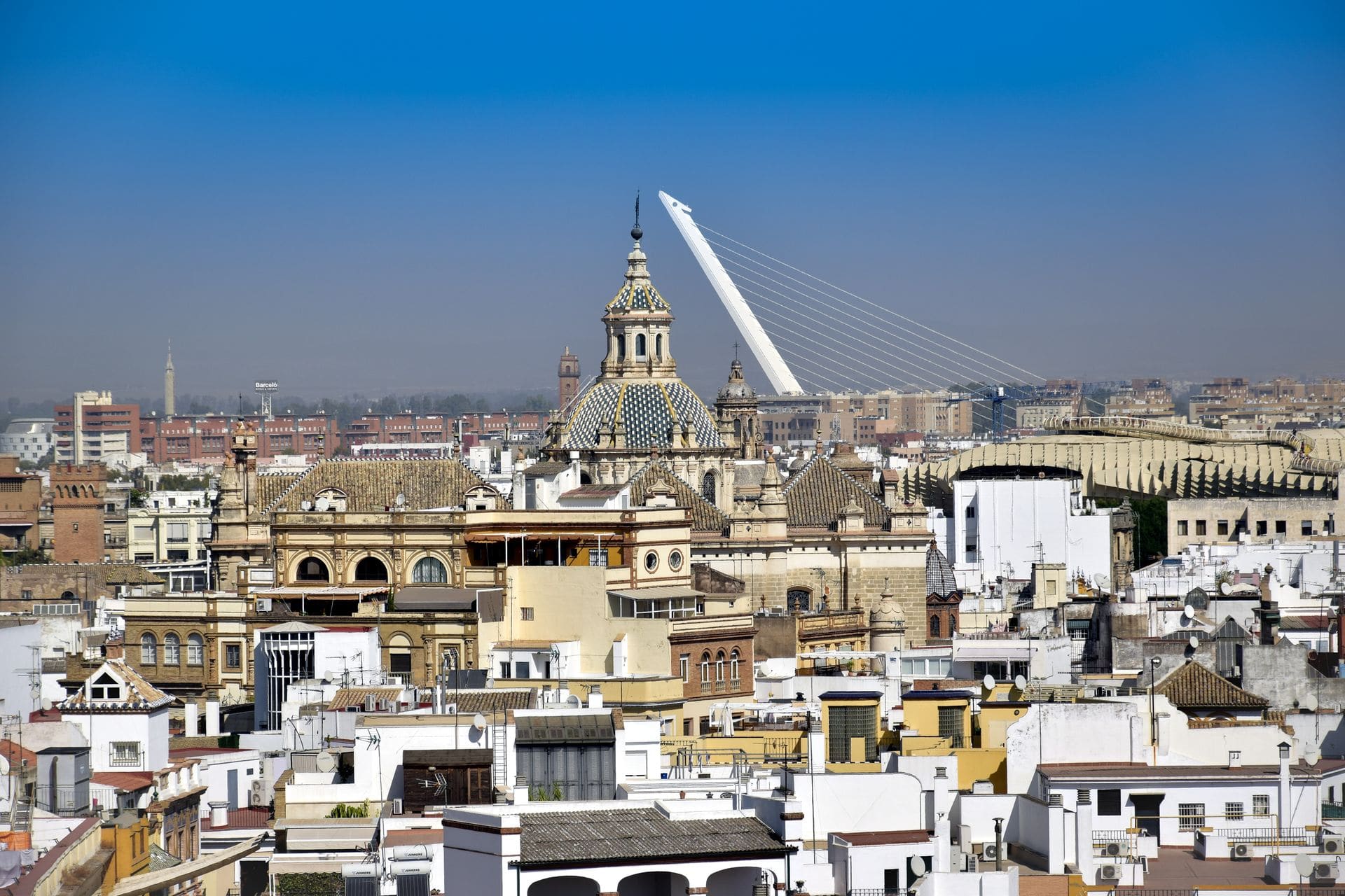 Elevated view of Sevilla's skyline showcasing historic architecture and the Puente del Alamillo.