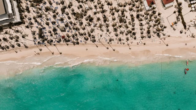 Stunning aerial view of a tropical beach in the Dominican Republic with white sand and turquoise water.