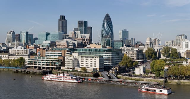 The City of London skyline as viewed toward the north-west from the top floor viewing platform of London City Hall on the southern side of the Thames. In the foreground: Dixie Queen and Millennium Time at Tower Millennium Pier. This is a 5 segment panoramic image taken by myself with a Canon 5D and 24-105mm f/4L IS lens.