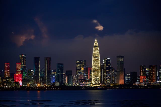 A breathtaking cityscape at night, showcasing illuminated skyscrapers and a vibrant skyline.