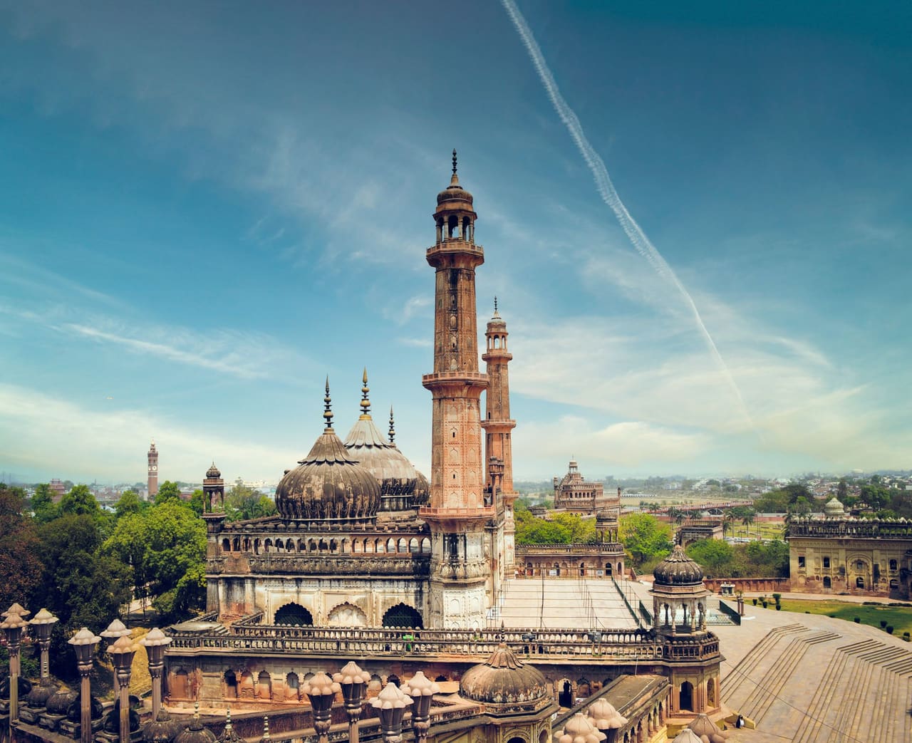 A striking view of a historic mosque with minarets in Lucknow, India, showcasing architectural beauty.