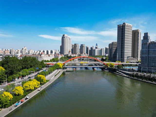 Stunning aerial view of Tianjin cityscape, featuring the Haihe River and modern architecture.