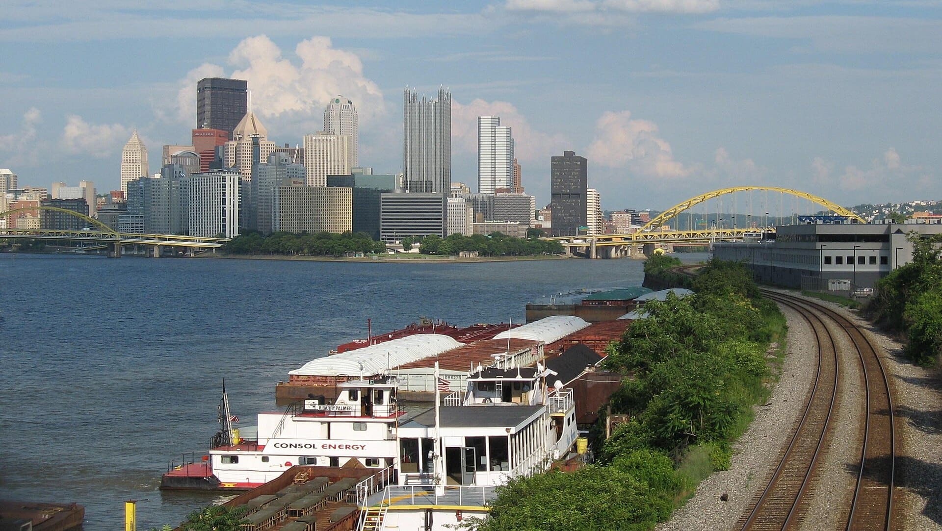 Pittsburgh skyline from the West End Bridge, with barges and railroad tracks