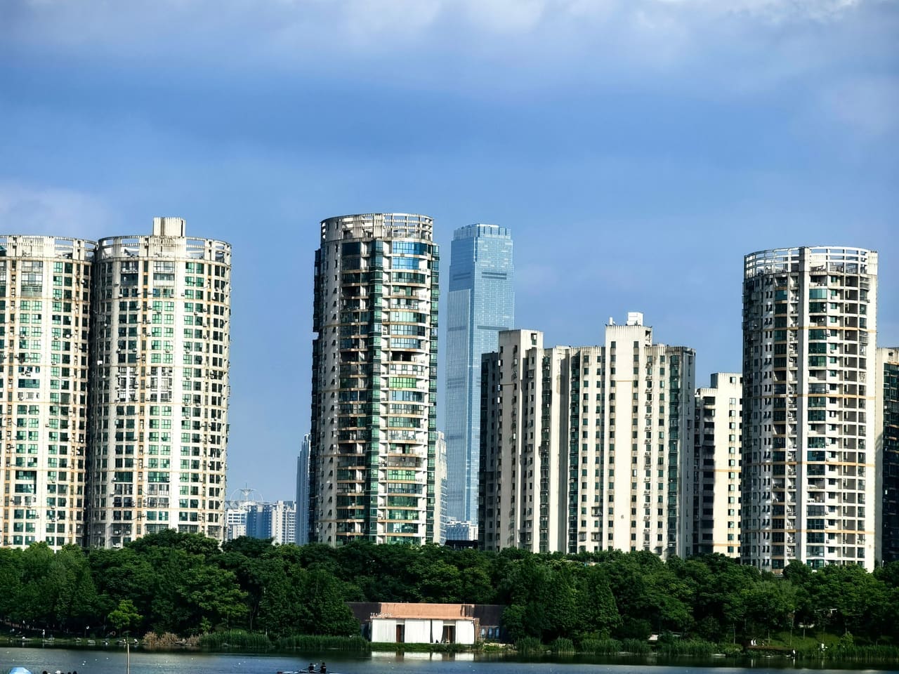 Panoramic view of Changsha's urban skyline showcasing modern high-rise buildings against a blue sky.