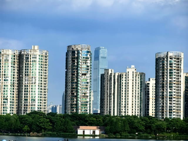 Panoramic view of Changsha's urban skyline showcasing modern high-rise buildings against a blue sky.