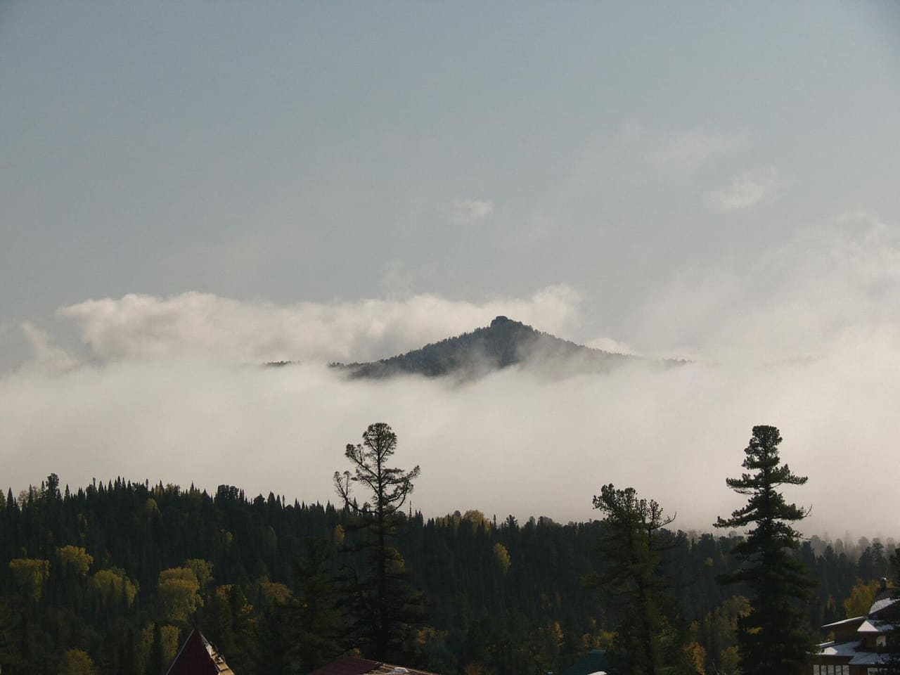 The skyline was all covered with clouds and only some peaks raised above the white veil.