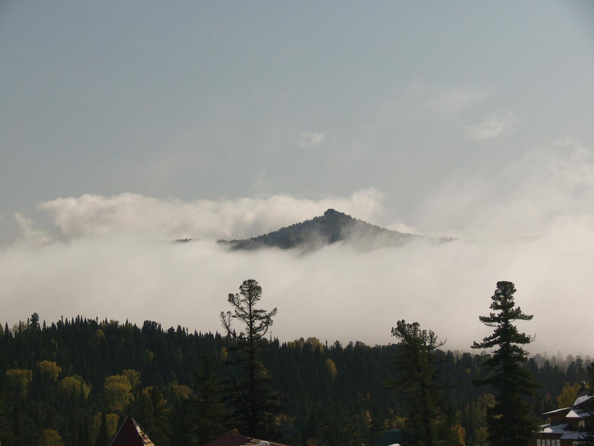The skyline was all covered with clouds and only some peaks raised above the white veil.