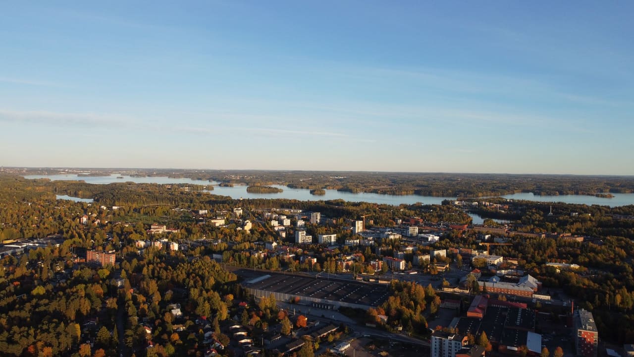 Scenic aerial view of Nokia, Finland showcasing lakes, forests, and urban landscape in autumn.