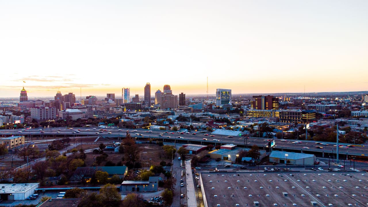 A breathtaking aerial view of San Antonio's skyline during sunset, showcasing its urban charm and high-rise buildings.