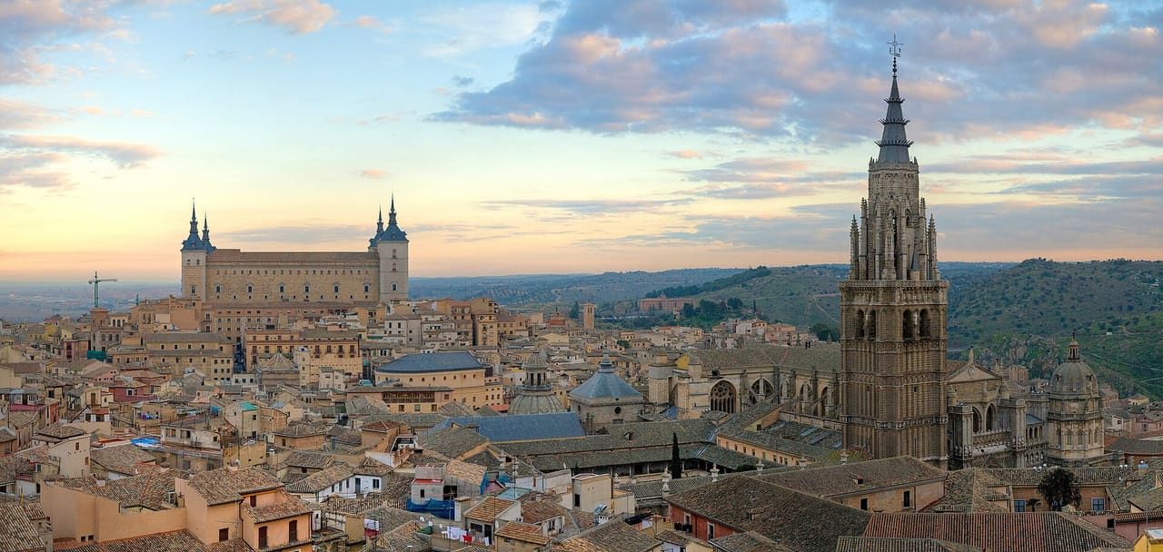 A 4 x 1 segment panorama of the Toledo Skyline in Spain at sunrise. Taken by myself in portrait format with a Canon 5D and 70-200mm f/2.8L lens. On the left Alcázar of Toledo and on the right Cathedral of Toledo.