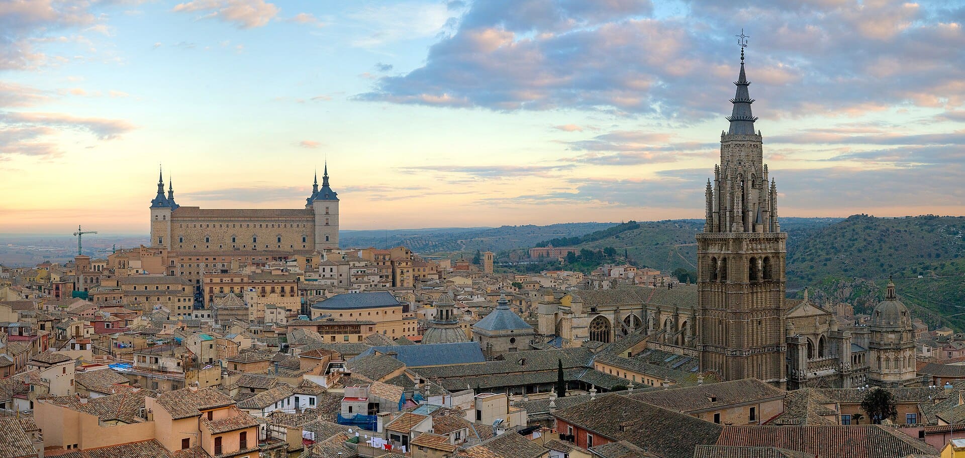 A 4 x 1 segment panorama of the Toledo Skyline in Spain at sunrise. Taken by myself in portrait format with a Canon 5D and 70-200mm f/2.8L lens. On the left Alcázar of Toledo and on the right Cathedral of Toledo.