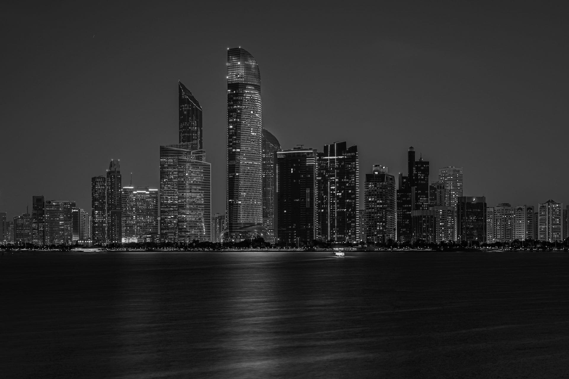 Captivating black and white cityscape of Abu Dhabi's skyline at night.