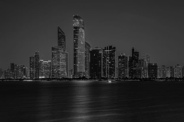Captivating black and white cityscape of Abu Dhabi's skyline at night.