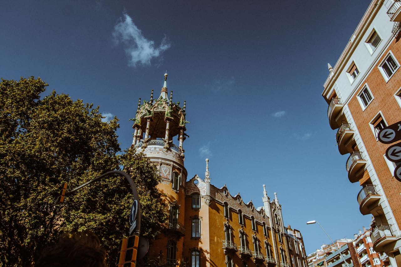 A beautiful historic building in Barcelona adorned with intricate details under a clear blue sky, showcasing stunning architecture.