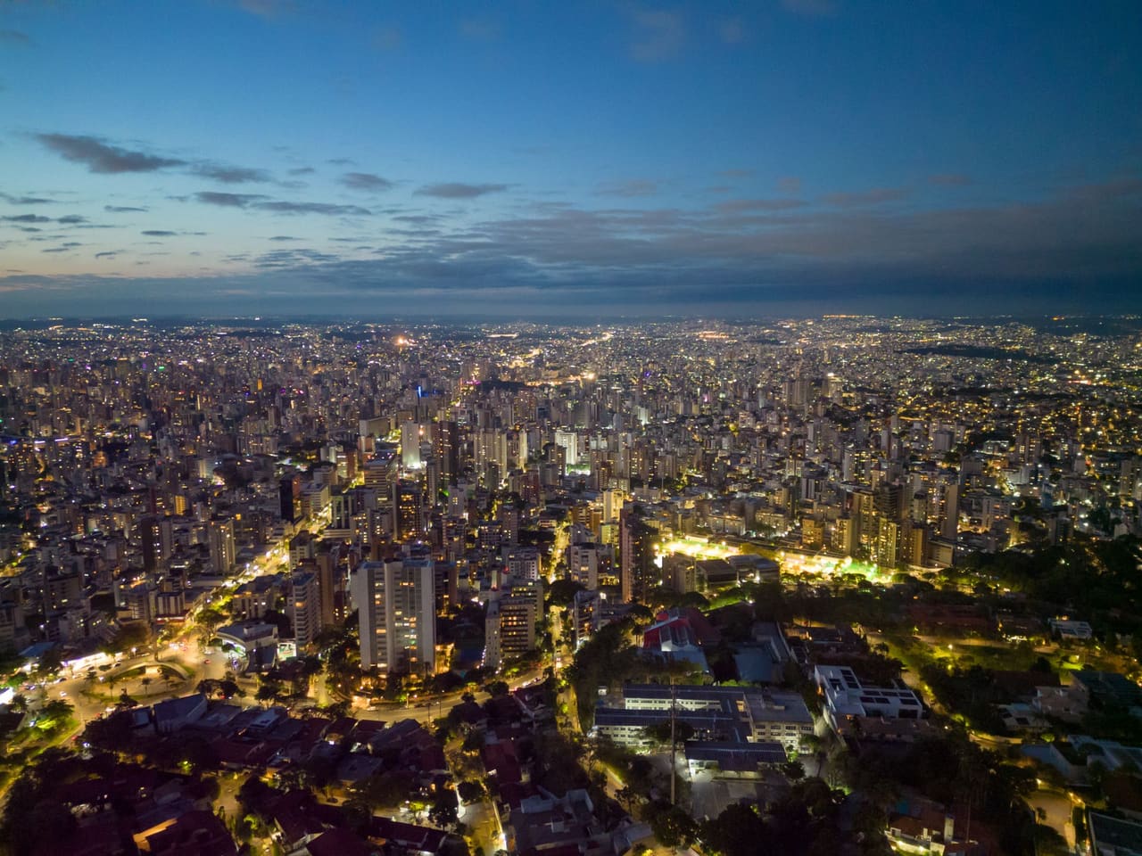 Captivating aerial cityscape of Belo Horizonte, Brazil at dusk, showcasing urban lights and skyline.