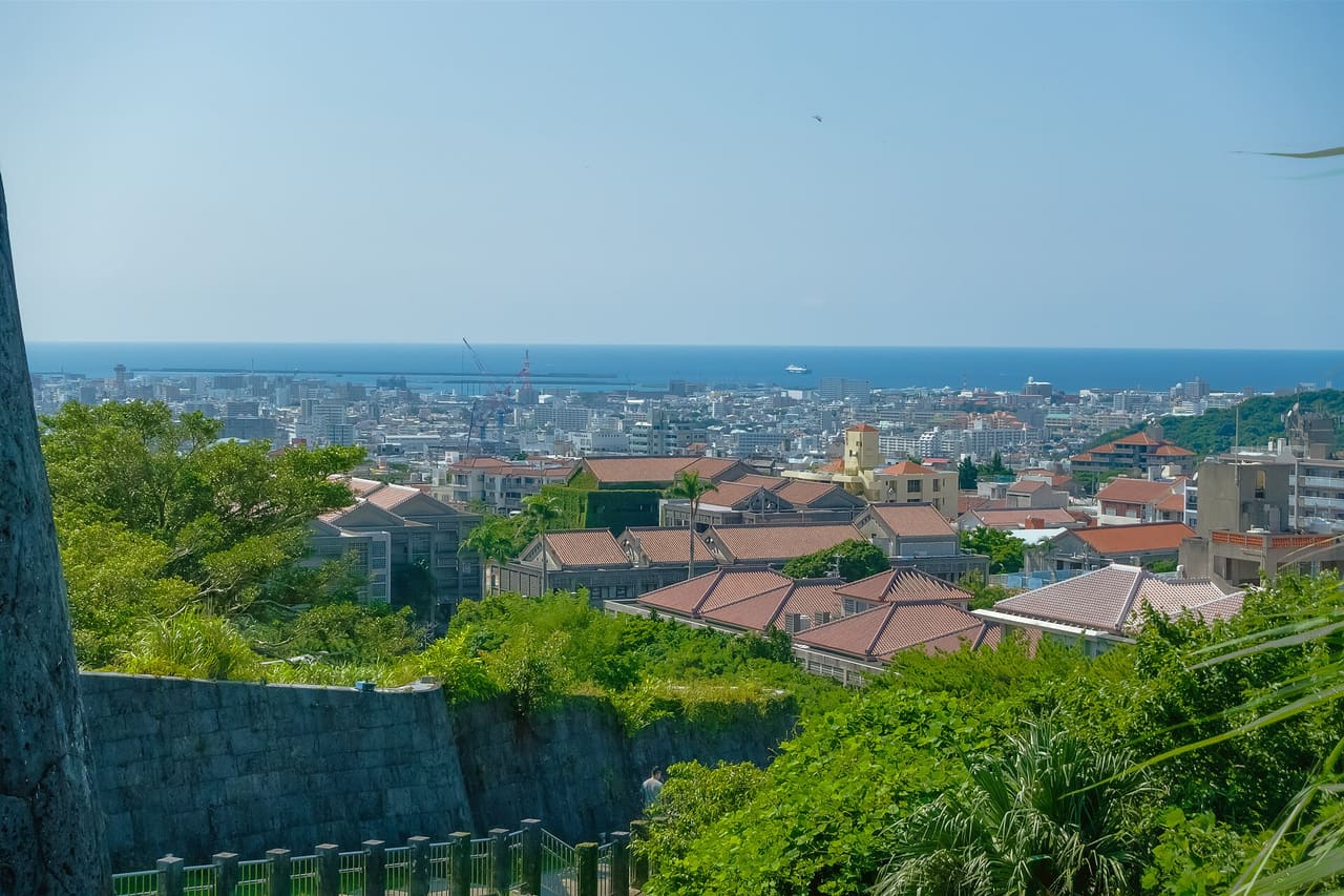 Okinawa Naha City Skyline Scenery from Shurijo castle park trail lookout. That location maybe can clearly seeing some buildings red roofs of Okinawa Prefectural University of Arts and other houses roof in the around of the University campus. This is a HDR photo Photography Date: 12 August 2024 Camera: Sony ZV-1