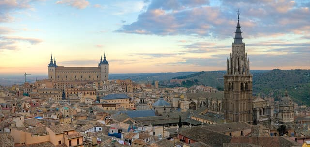 A 4 x 1 segment panorama of the Toledo Skyline in Spain at sunrise. Taken by myself in portrait format with a Canon 5D and 70-200mm f/2.8L lens. On the left Alcázar of Toledo and on the right Cathedral of Toledo.