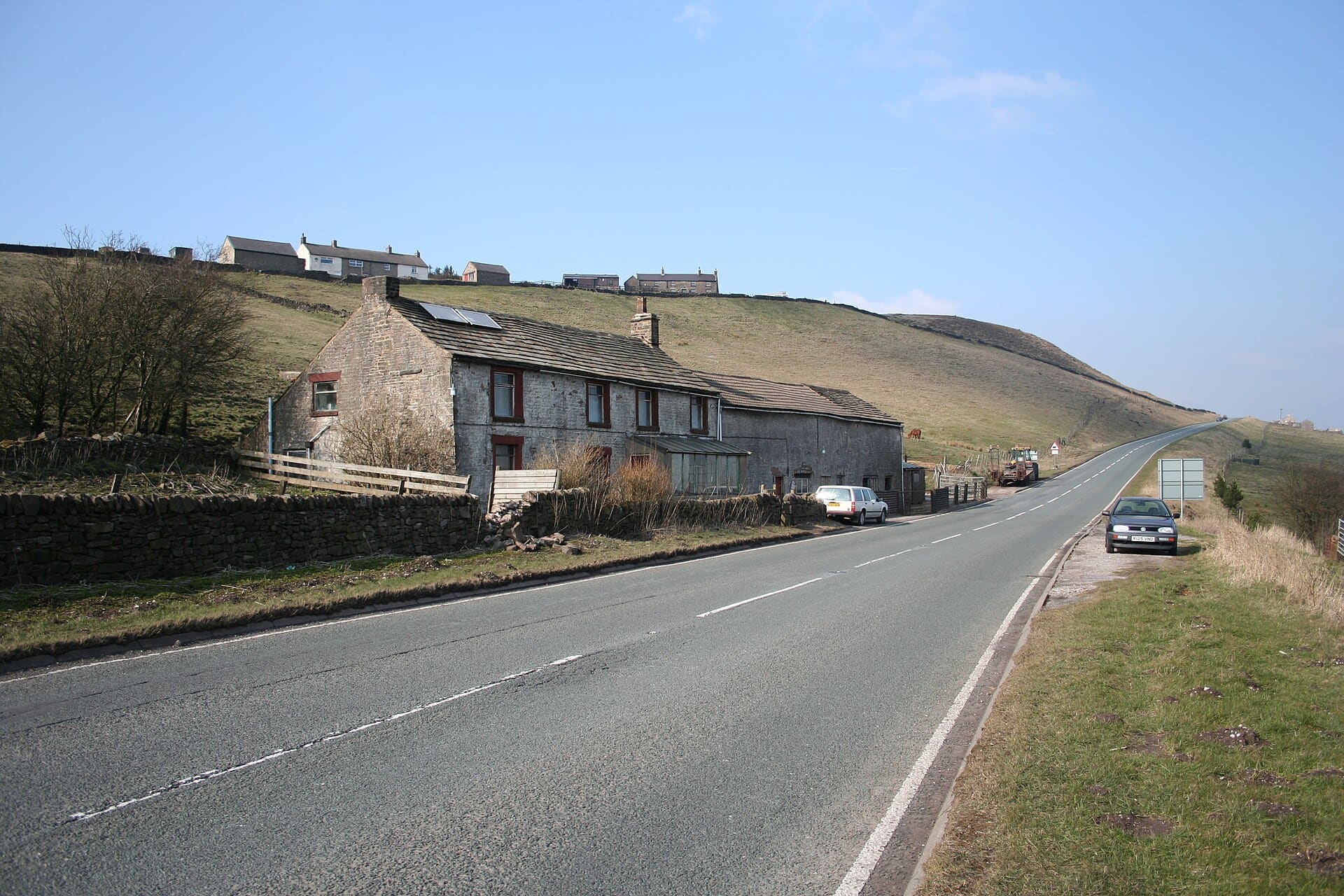 Dove Head Farm and A53 Looking towards Buxton on the A53. The source of the River Dove lies below this farm (on the right-hand side of the road). On the skyline are the cottages of Axe Edge End.